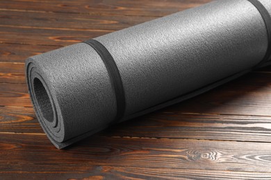 Photo of One grey yoga mat on wooden floor