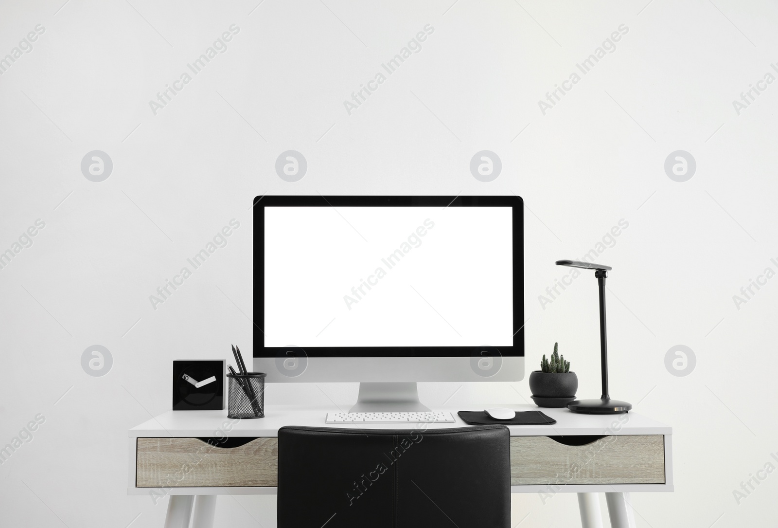 Photo of Modern computer with blank screen on desk, space for design. Comfortable workplace