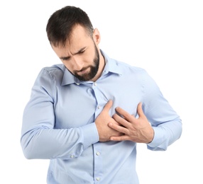 Young man suffering from chest pain on white background