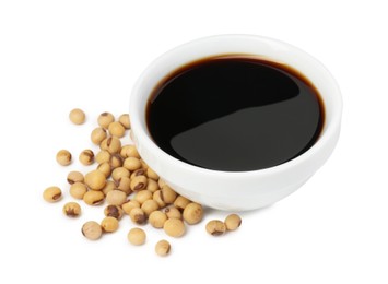 Photo of Tasty soy sauce in bowl and soybeans isolated on white