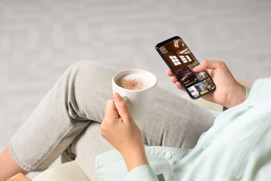 Woman using smart home security system on mobile phone indoors, closeup. Device showing different rooms through cameras