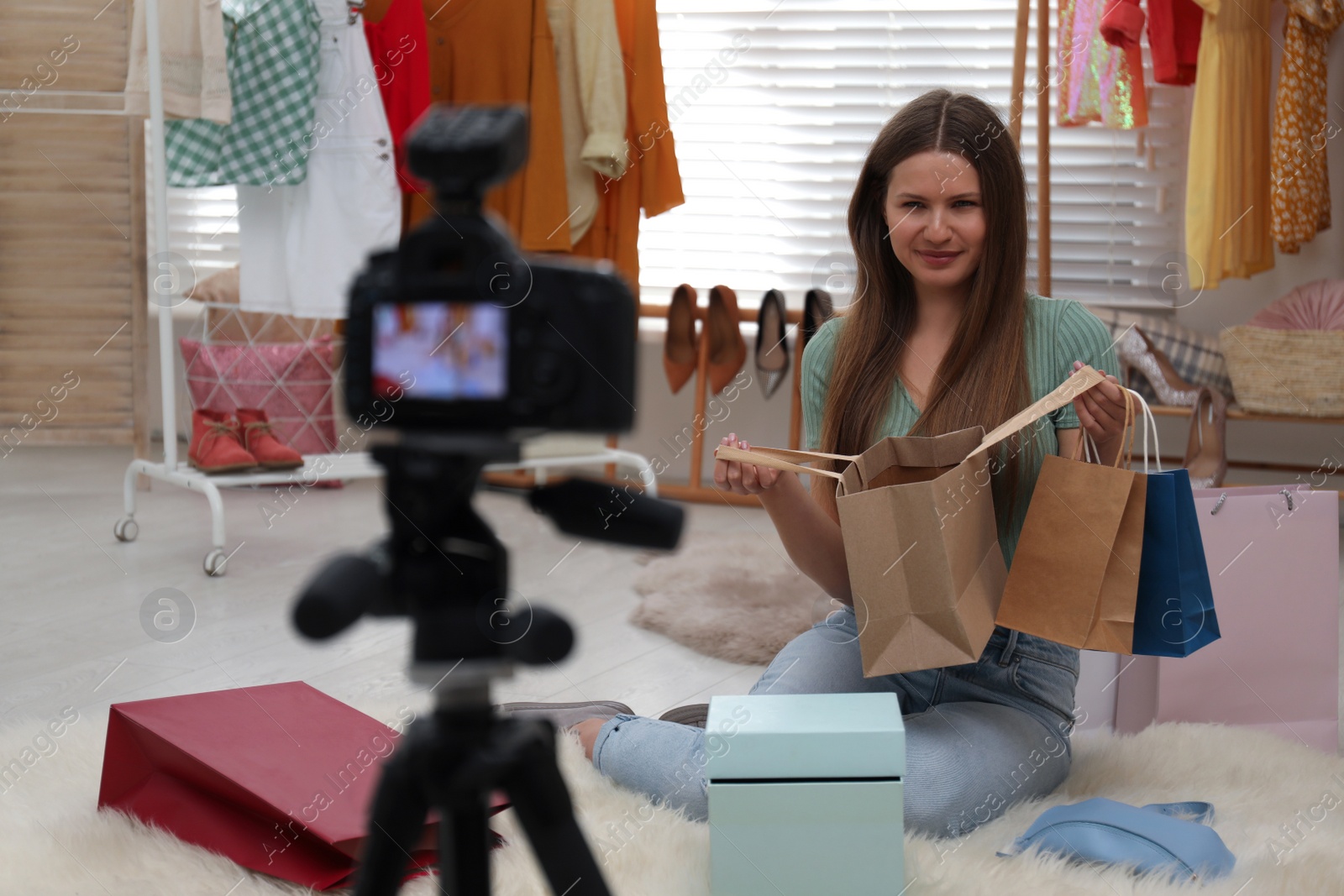 Photo of Fashion blogger recording new video in room