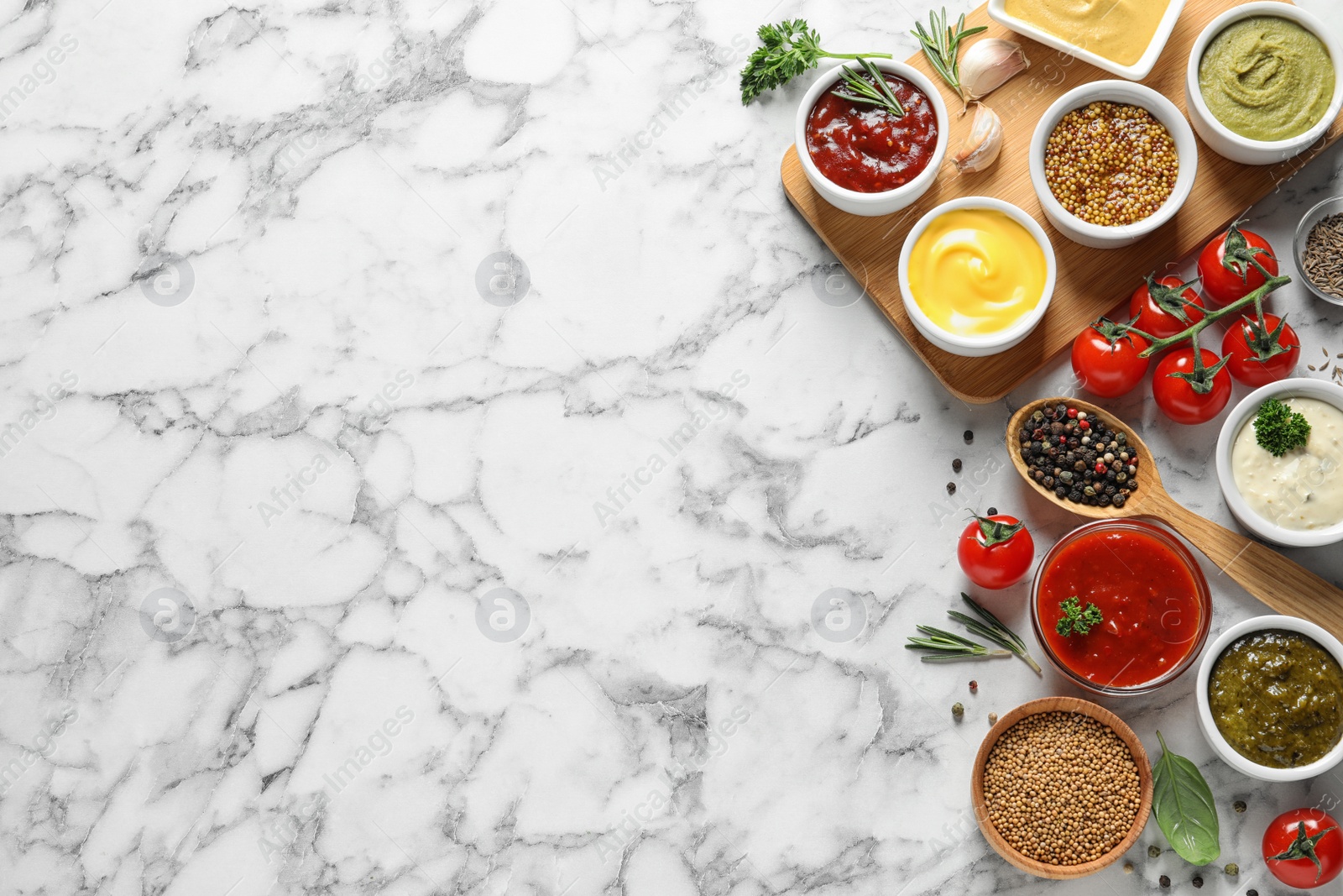 Photo of Flat lay composition with different sauces and space for text on marble background