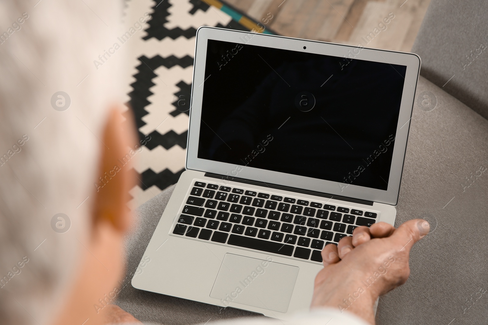 Photo of Man using video chat on laptop at home, closeup. Space for text