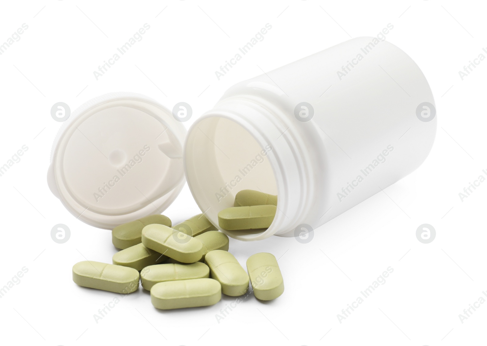 Photo of Vitamin pills and bottle isolated on white