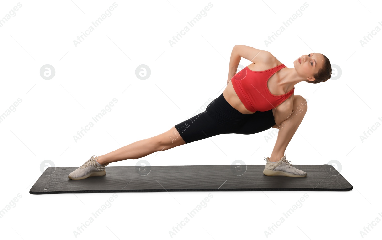 Photo of Yoga workout. Young woman stretching on white background