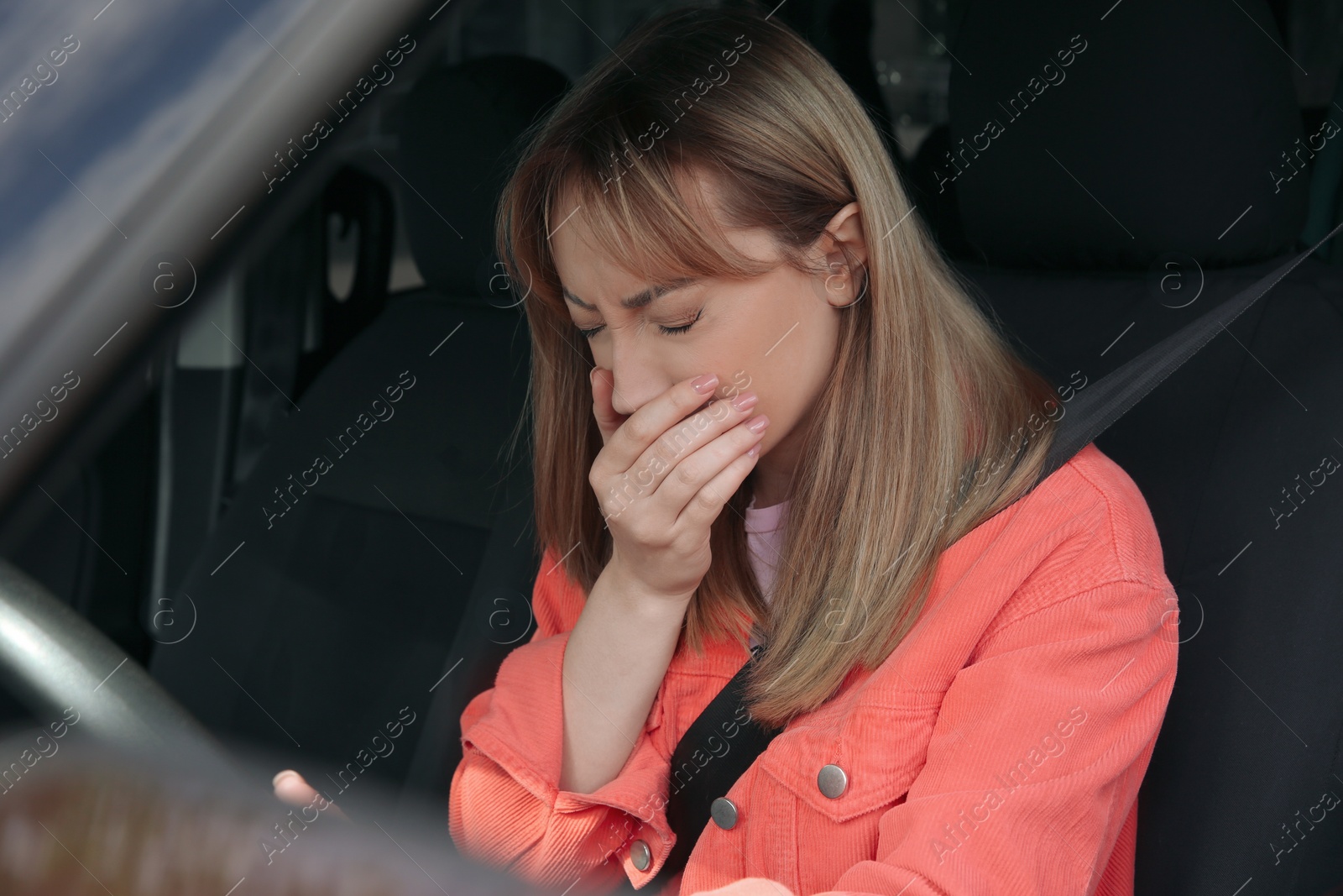 Photo of Young woman suffering from nausea in car