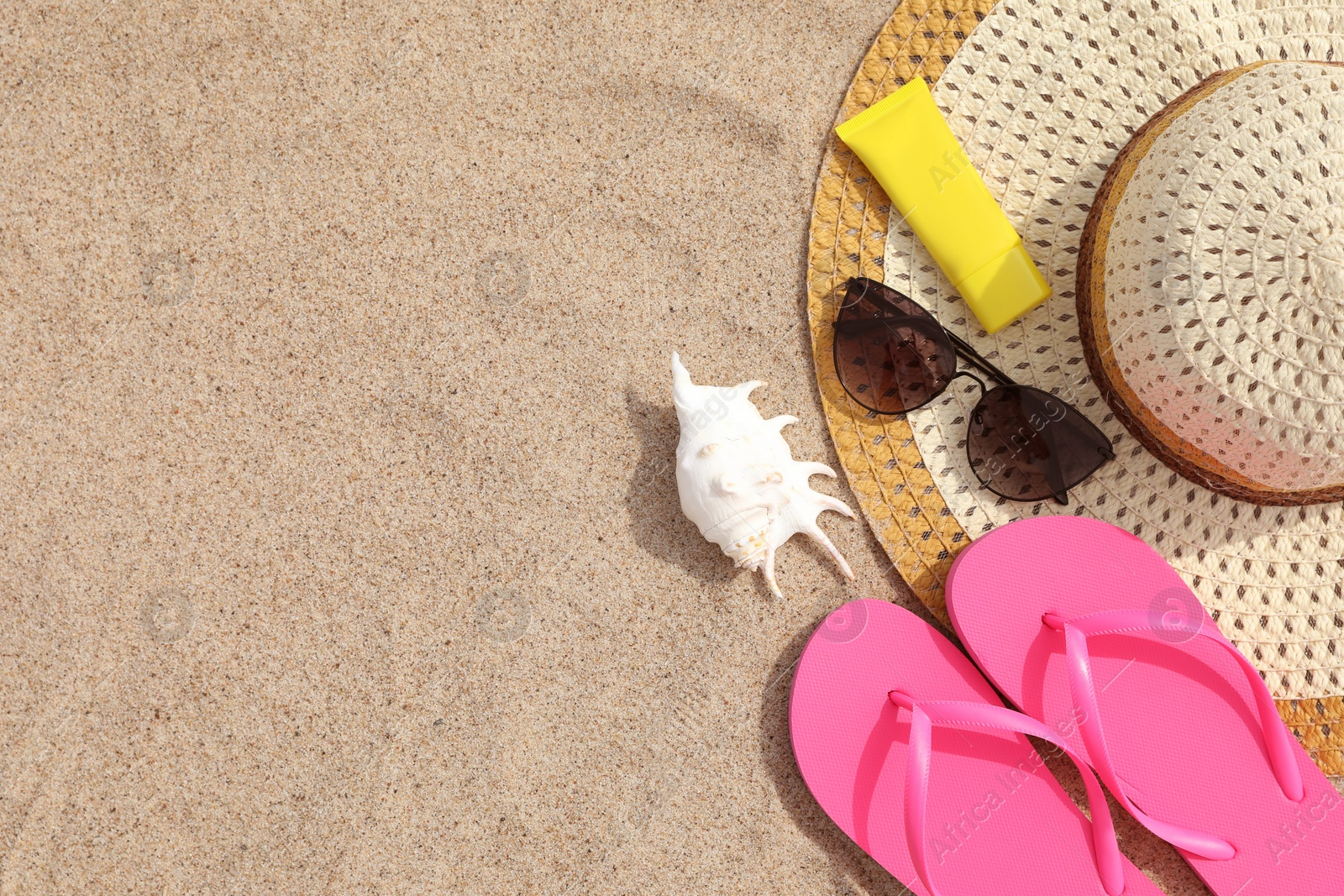 Photo of Flat lay composition with bright flip flops on sand. Space for text