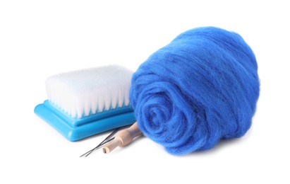 Blue felting wool, needles and brush isolated on white