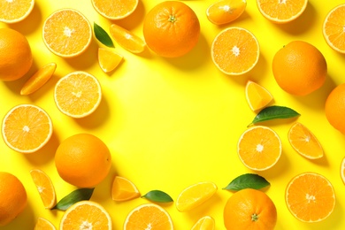 Photo of Flat lay composition with ripe oranges and space for text on color background