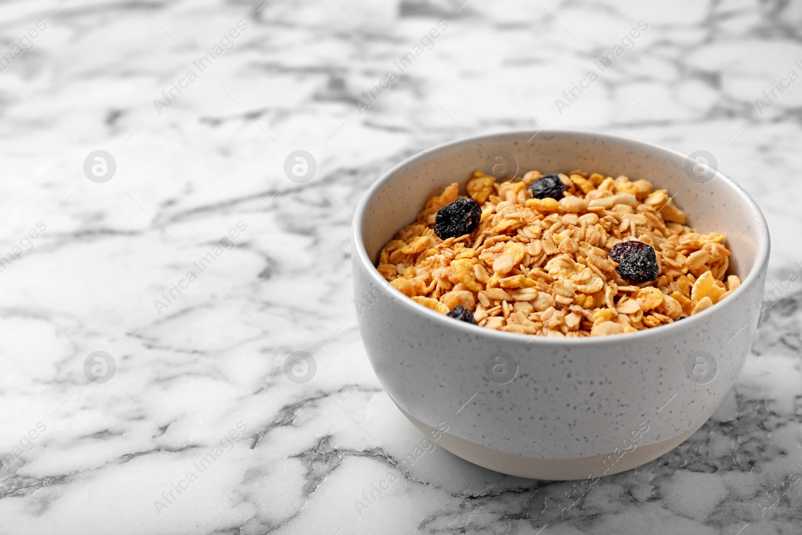 Photo of Bowl with whole grain cereal on marble table