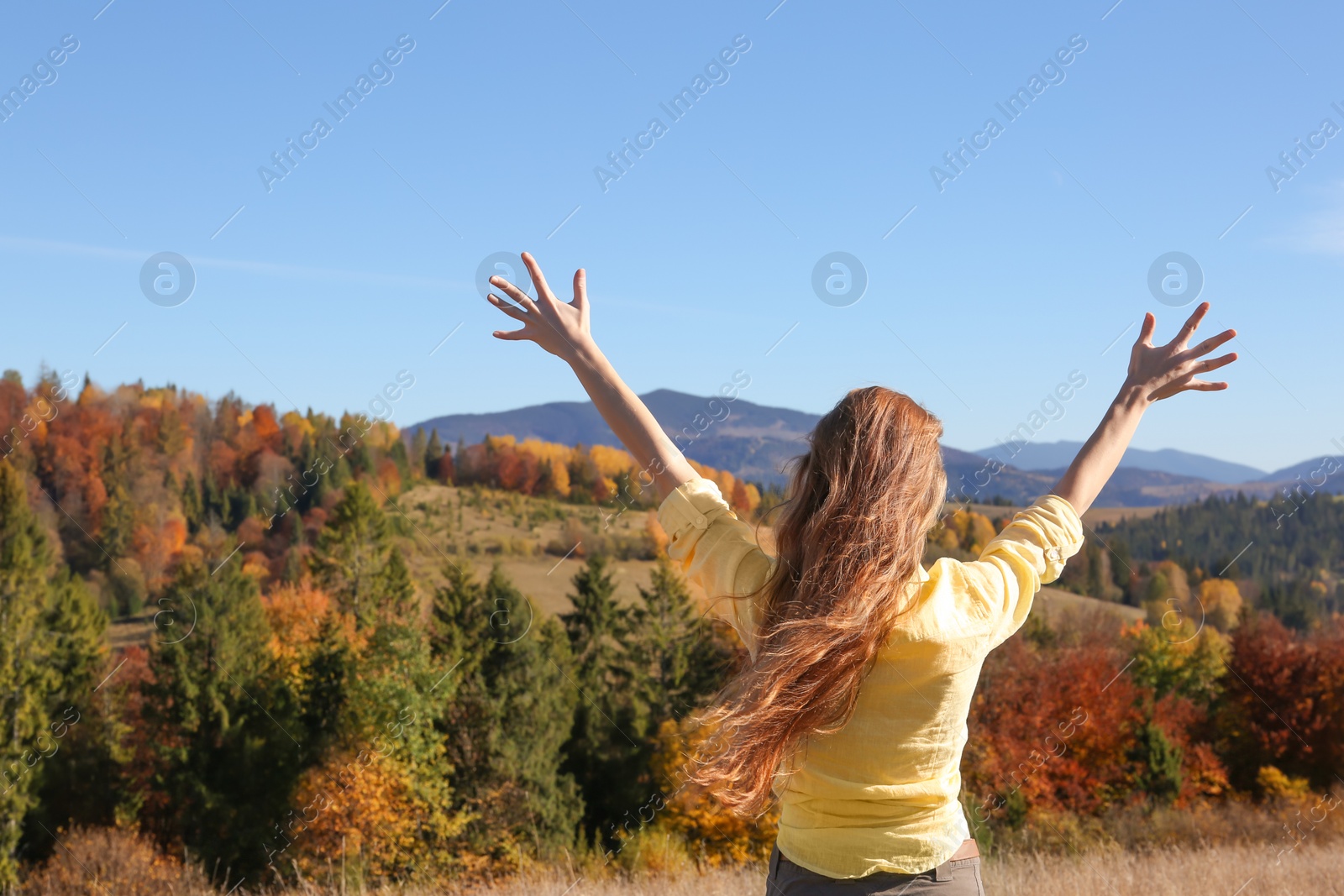 Photo of Female traveler feeling free in peaceful mountains