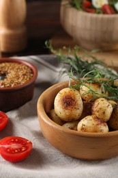 Delicious grilled potatoes with tarragon on table