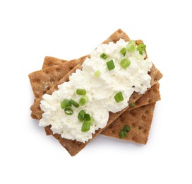 Crispy crackers with cottage cheese and green onion on white background, top view