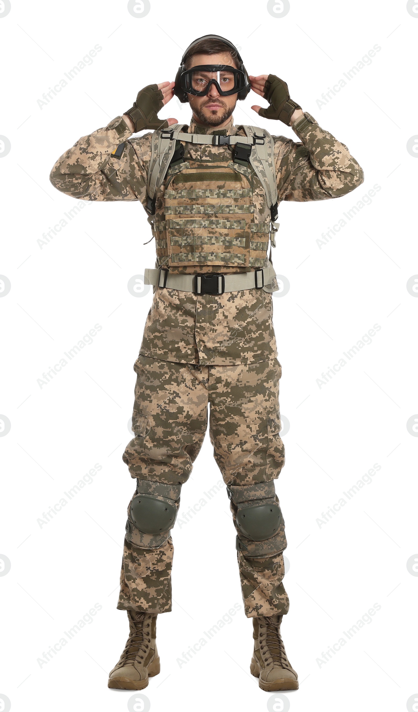 Photo of Soldier in Ukrainian military uniform, tactical goggles and headphones on white background