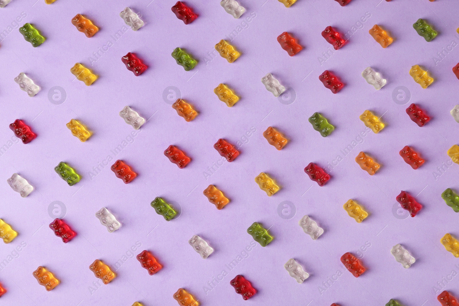 Photo of Flat lay composition with delicious jelly bears on color background