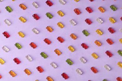 Flat lay composition with delicious jelly bears on color background