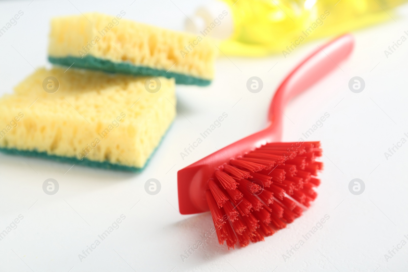 Photo of Cleaning brush for dish washing on white background, closeup