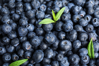 Fresh tasty blueberries as background, closeup view