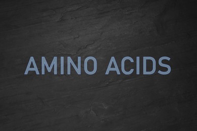 Illustration of Text Amino Acids on black slate surface