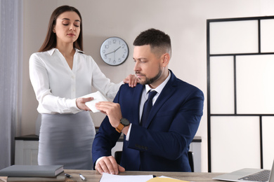 Woman giving bribe to man at table in office