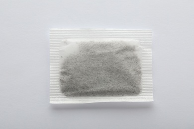 Photo of Unused tea bag on white background, top view