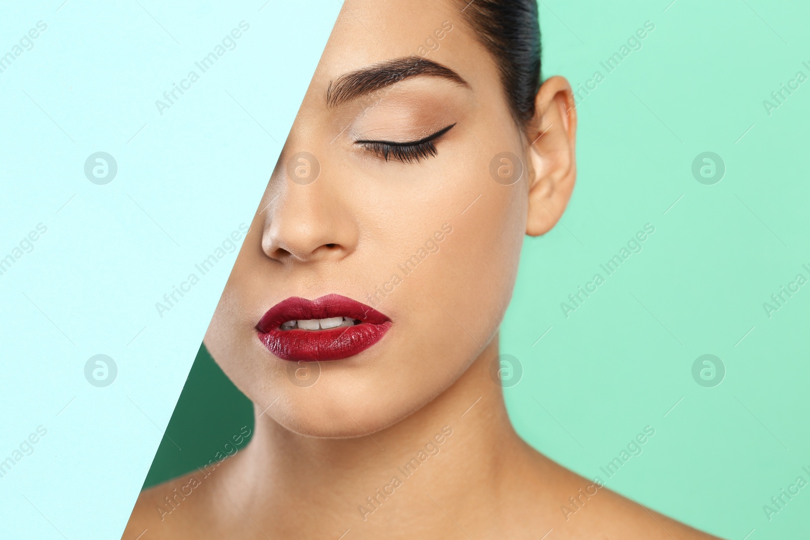 Photo of Young woman wearing beautiful lipstick on color background