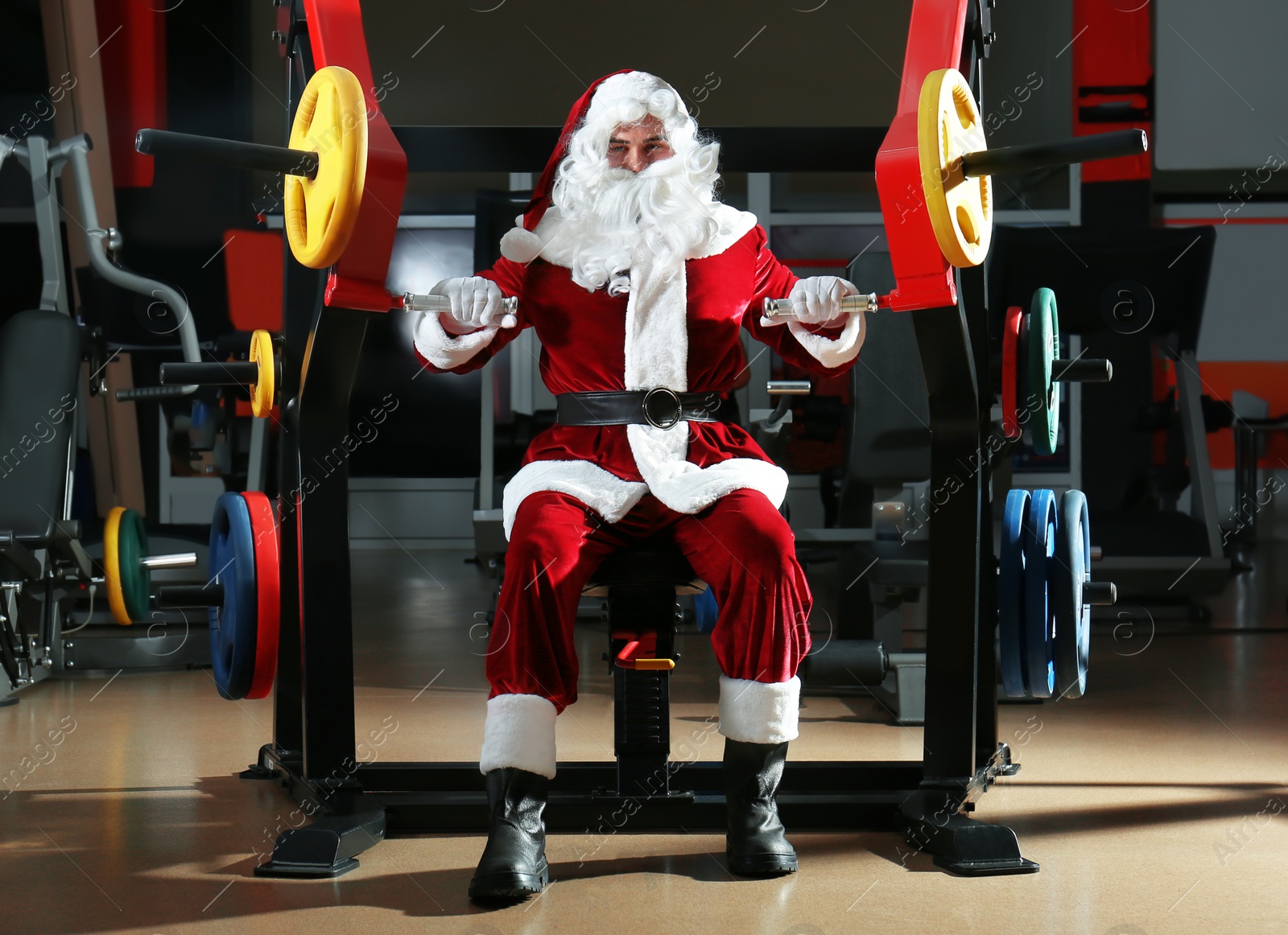 Photo of Young Santa Claus training in modern gym