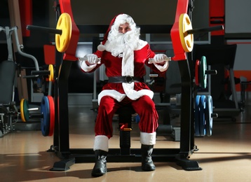 Photo of Young Santa Claus training in modern gym