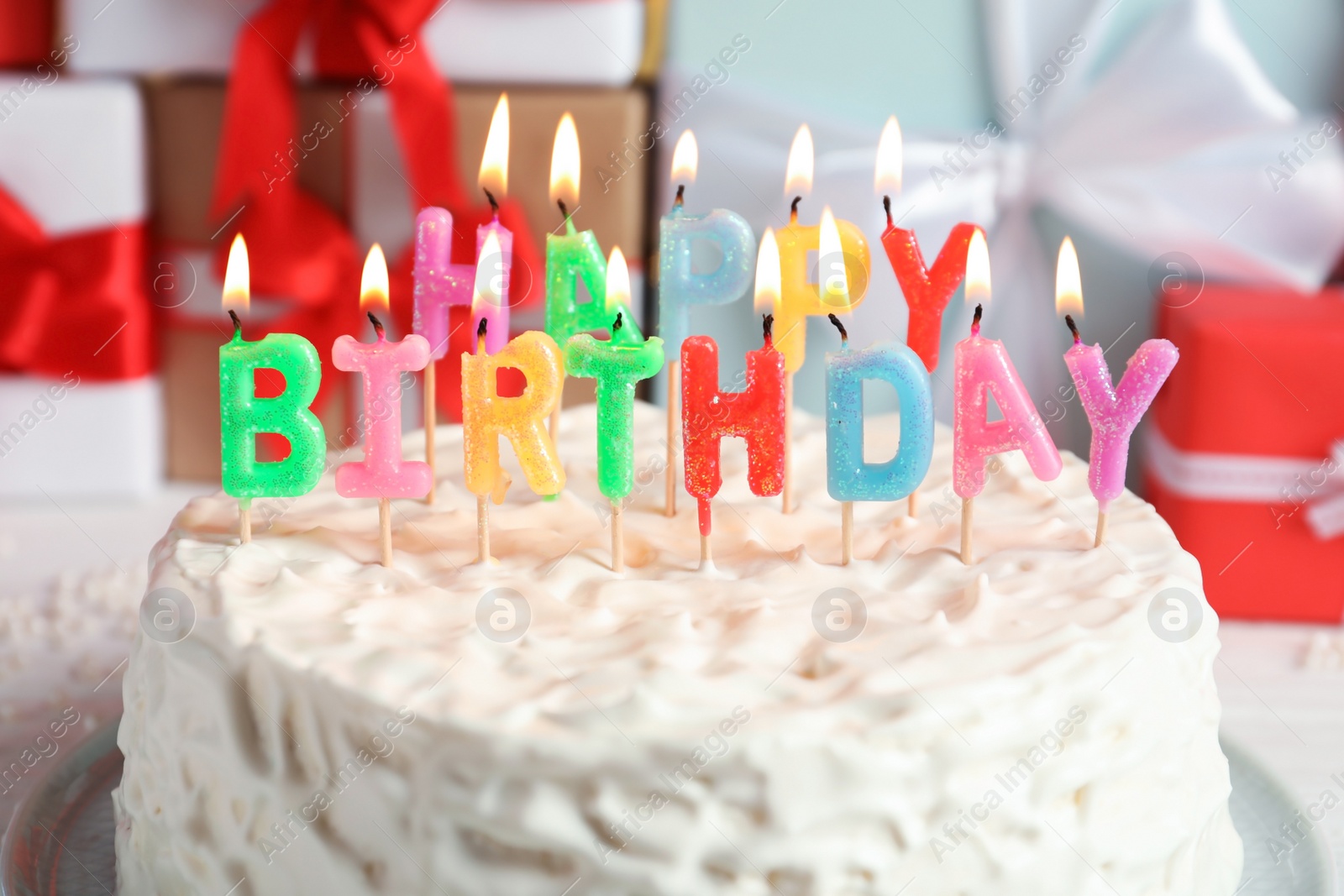 Photo of Delicious birthday cake with burning candles, closeup