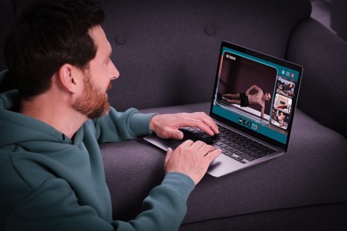 Image of Personal trainer online. Man viewing website via laptop at home