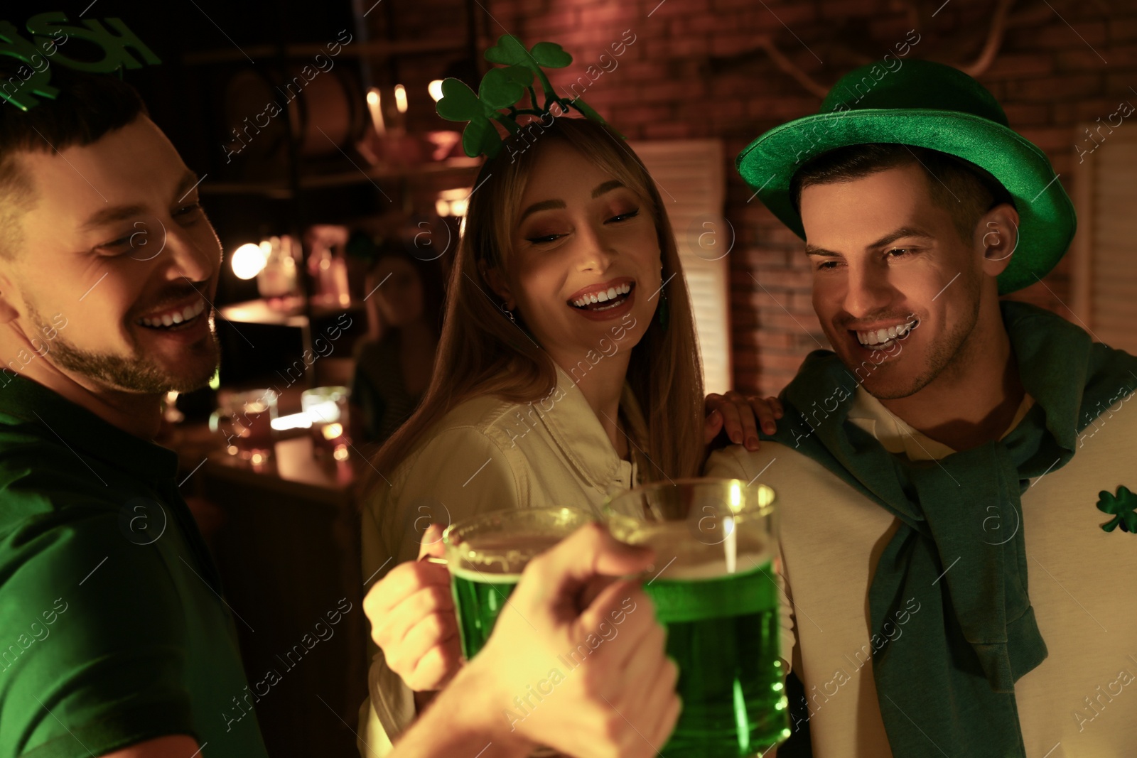 Photo of People with beer celebrating St Patrick's day in pub