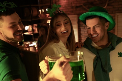People with beer celebrating St Patrick's day in pub