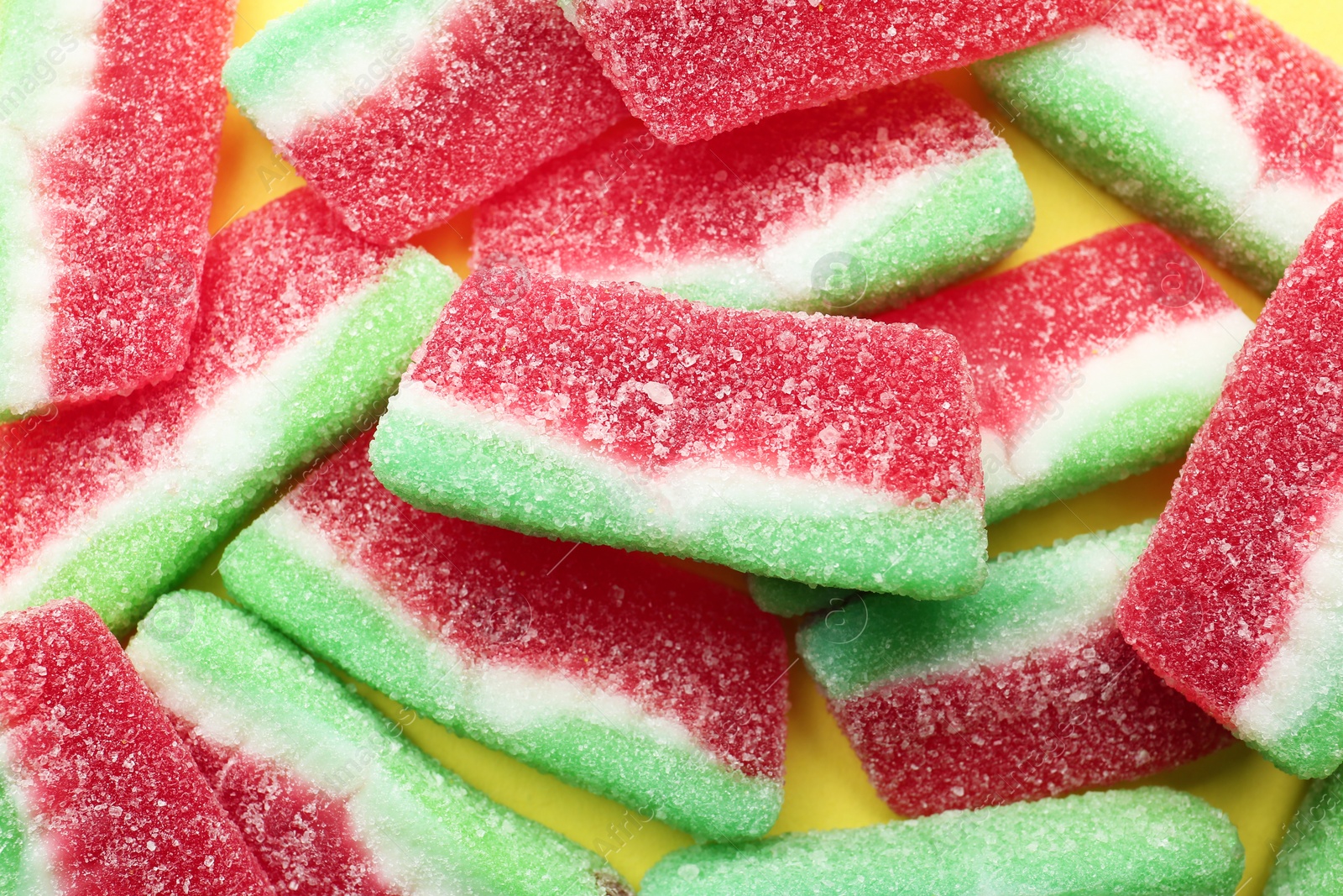 Photo of Tasty jelly candies on color background, top view