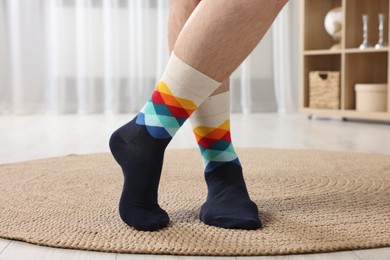Man in stylish colorful socks indoors, closeup