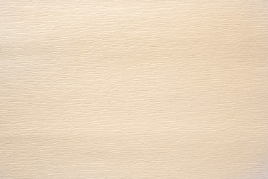 Photo of Texture of beige paper sheet as background, closeup