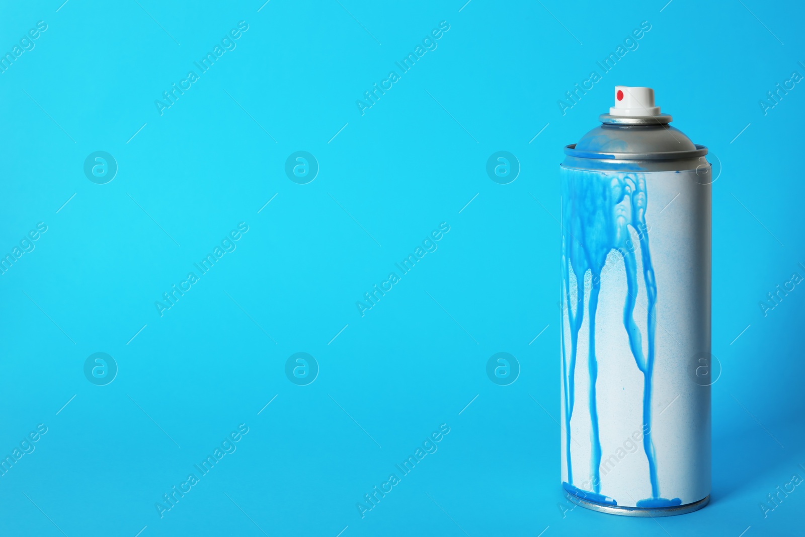 Photo of Used can of spray paint on color background. Space for text