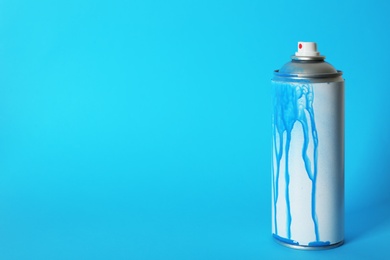 Photo of Used can of spray paint on color background. Space for text