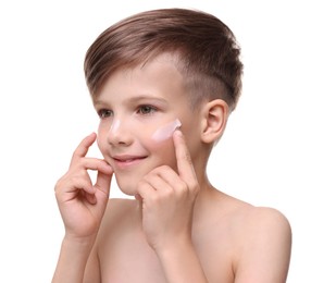 Photo of Happy boy applying sun protection cream onto his face against white background