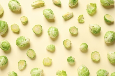 Photo of Fresh Brussels sprouts on color background, flat lay