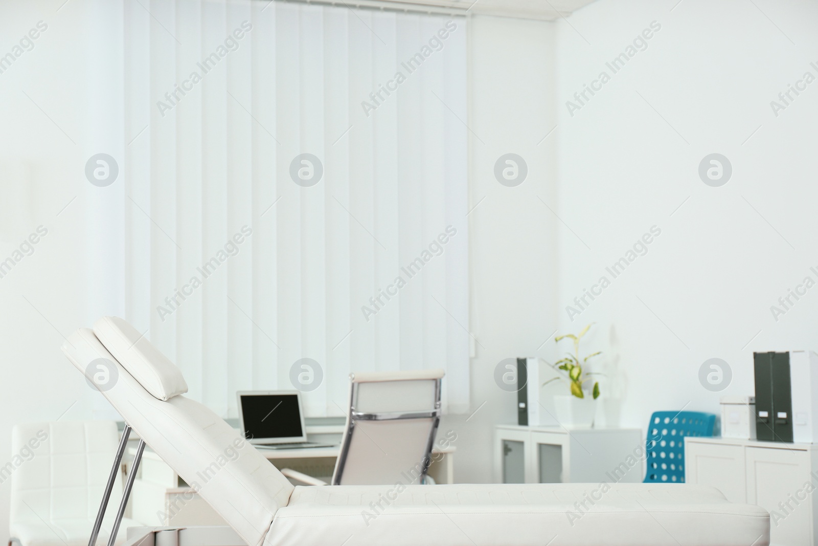 Photo of Modern medical examination couch in doctor's office
