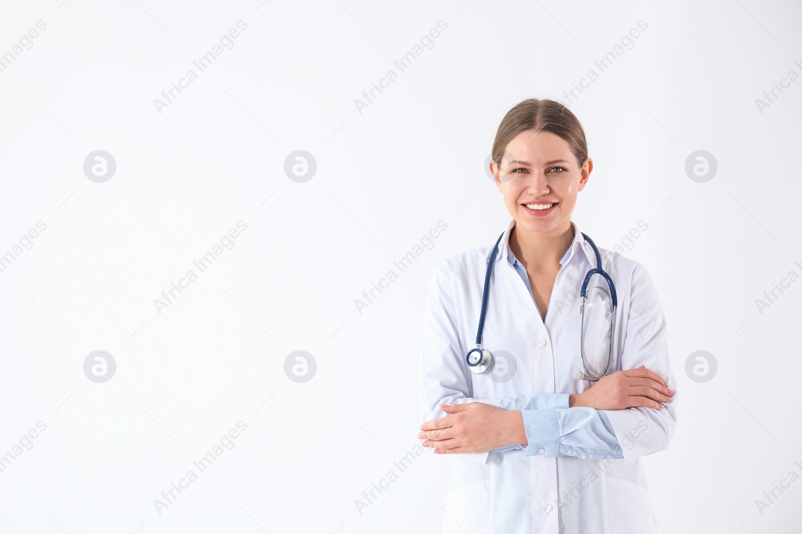 Photo of Portrait of young doctor against white background