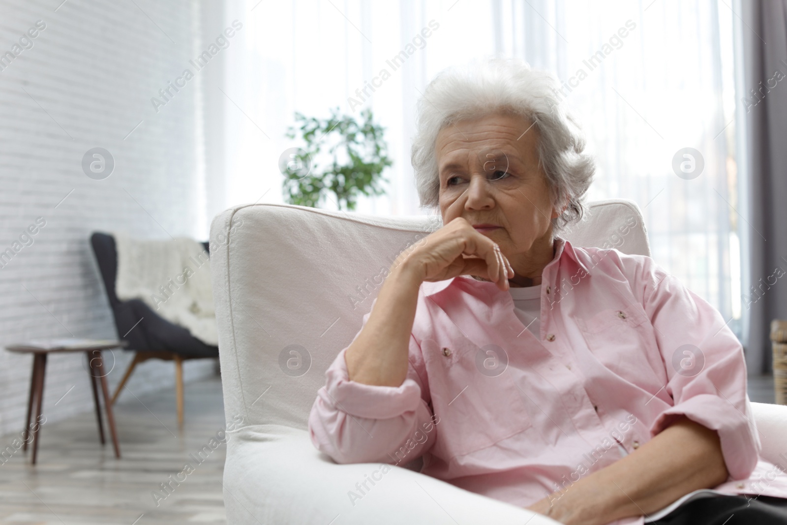 Photo of Portrait of mature woman in living room