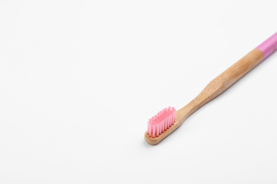 Photo of Bamboo toothbrush with pink bristle isolated on white