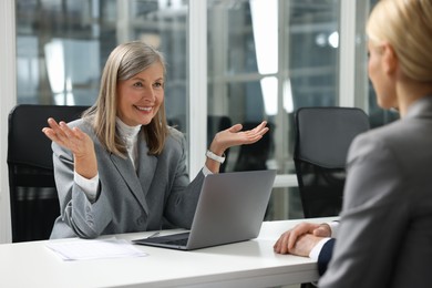 Photo of Lawyer working with clients at table in office