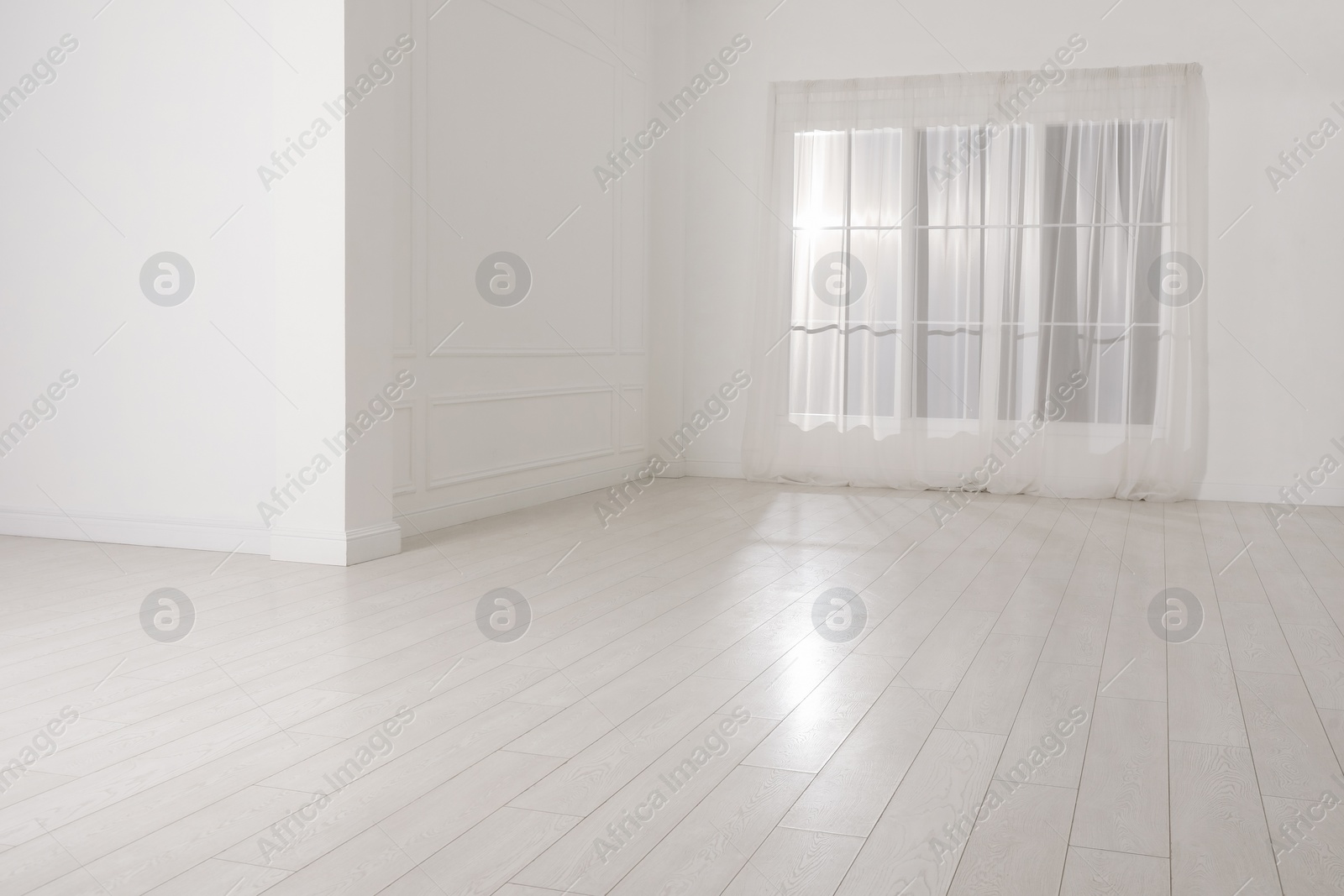 Photo of Empty room with white walls and large window