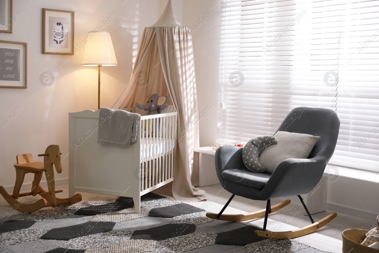 Photo of Baby room interior with comfortable crib and rocking chair