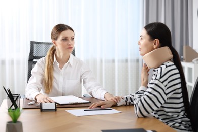 Photo of Injured woman having meeting with lawyer in office