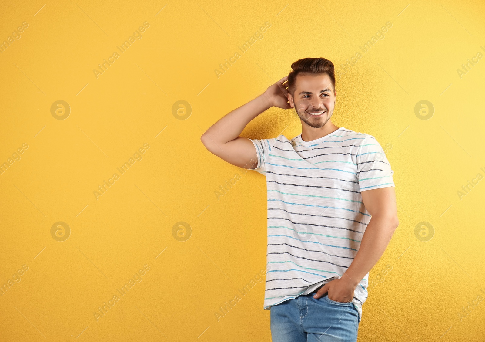 Photo of Young man in stylish jeans on color background