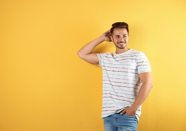 Photo of Young man in stylish jeans on color background